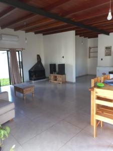 a living room with a couch and a fireplace at Casa amplia y bien ubicada in Artigas