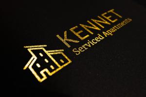 a close up of a yellow logo on a black shirt at Elm House in Reading