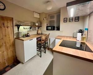a kitchen with a white refrigerator and a counter at Chapter Cottage, Cheddleton Nr Alton Towers, Peak District, Foxfield Barns in Cheddleton