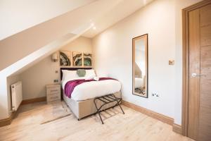 a bedroom with a bed and a mirror at Elm House in Reading