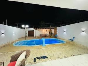 a large swimming pool in the middle of a building at Linda casa com piscina in São Miguel do Gostoso