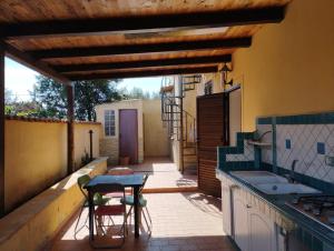 a kitchen with a table and chairs on a patio at Villa Madreselva in Cinisi