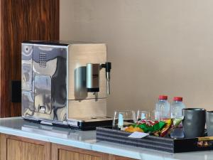 a microwave sitting on top of a counter with drinks at Downtown Oasis, Burj Khalifa Views, Luxury Amenities in Dubai