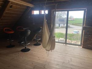 a hammock in a room with chairs and a window at HolidayEscapes på Österlen in Simrishamn