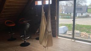 a room with a large window and a broom hanging from a wall at HolidayEscapes på Österlen in Simrishamn
