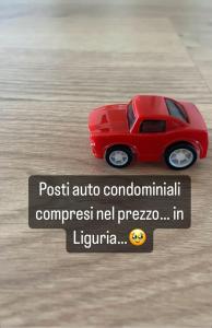 a small red toy car on a table at Mapa Holiday Sanremo 25 in Sanremo