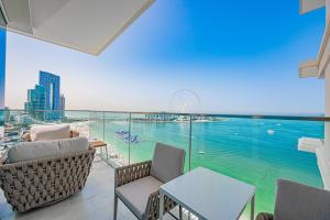 a balcony with chairs and a view of the water at La Vie in Dubai