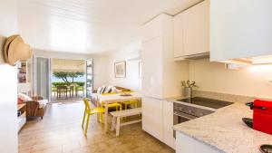 a kitchen and living room with a table and chairs at Villa Marina in Pelekas