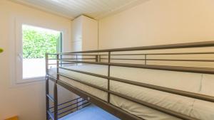 two bunk beds in a room with a window at Villa Marina in Pelekas