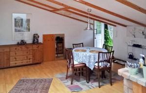 a dining room with a table and chairs at Cozy Apartment In Rheinsberg Ot Linow With Kitchen in Linow
