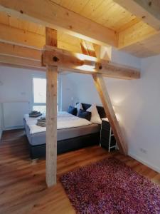 a loft bed in a room with a large bed at Alte Försterei Goldbeck in Rinteln