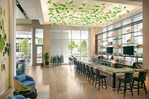 a bar in a lobby with chairs and tables at InterContinental Houston by IHG in Houston