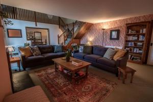 a living room with a couch and a coffee table at The Wheelhouse at Hewish Mill in Bittadon