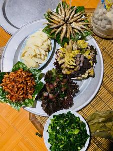 a table with three plates of food on it at Wooden floor house Ngọc trinh Homestay in Bản Qua