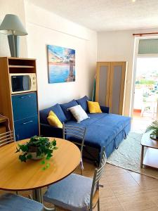a living room with a blue couch and a table at Apartment 505 in São Martinho do Porto