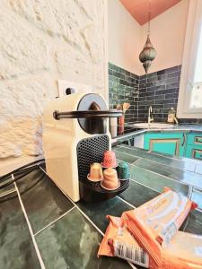 a kitchen with a stove with hats on a counter at suite orientale du vieux port in Marseille