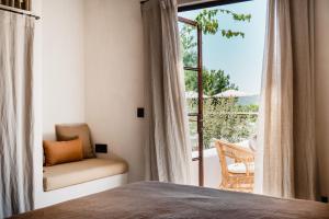 a bedroom with a bed and a window with a balcony at Aguamadera in Santa Eularia des Riu