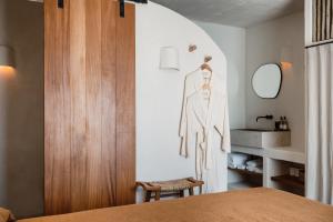 a bedroom with a robe hanging on a wall at Aguamadera in Santa Eularia des Riu