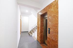 a hallway with stairs and a wall of marble at Hotel Trendy residency in New Delhi