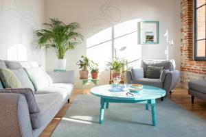 a living room with a couch and a coffee table at Évasions-Escapade, centre-ville, gare in Auterive +18 photos