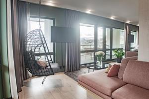 a living room with a couch and a swing at Hotel Norge by Scandic in Bergen