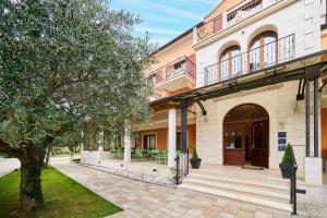 a building with a balcony on the side of it at Villa Dobravac Wine Estate in Rovinj