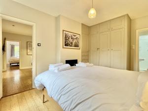 a bedroom with a large white bed in it at Mafeking in Benenden - an Inspire Stays home in Benenden