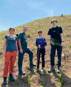 a group of people standing in a field at Wooden floor house Ngọc trinh Homestay in Bản Qua