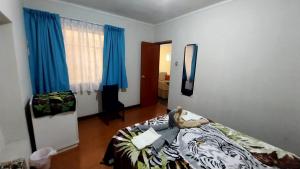 Un dormitorio con una cama con un osito de peluche. en Apartamentos Gutierrez en Lima