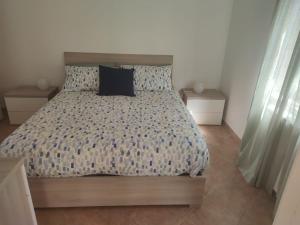 a bedroom with a bed and two night stands at La Passeggiata in Santa Marinella