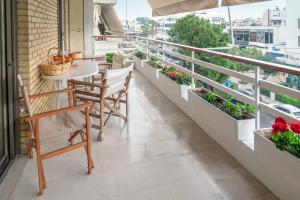 a balcony with a table and chairs and plants at Family Apt in Glyfada-Kyprou, by Comfortbnb in Athens