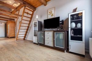 a living room with a television and a staircase at Storchenhorst 6 in Buchholz
