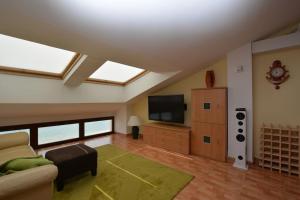 a living room with a couch and a flat screen tv at Private and charming apartment in front of the sea in Altafulla