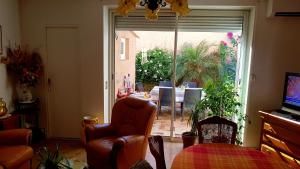a living room with a chair and a sliding glass door at maison plages et calanques 4/6 personnes in Marseille