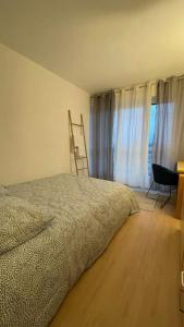 Ein Bett oder Betten in einem Zimmer der Unterkunft Bel appartement tout confort aux Portes de Paris