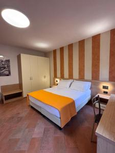 um quarto com uma cama grande e um cobertor laranja em Locanda Ca Da Iride em Riomaggiore