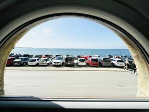 a view of a group of cars parked next to the ocean at APARTMA RIVIERA in Piran