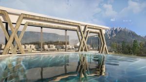 a swimming pool with a view of the mountains at Hotel Patris in Dobbiaco