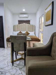 a living room with a couch and a table at Cozy Studio room, Wi-Fi & Smart TV in Lagos