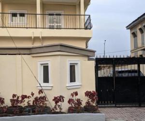 a building with a balcony and a black gate at Cozy Studio room, Wi-Fi & Smart TV in Lagos