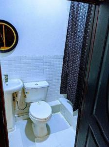 a bathroom with a toilet and a sink at Cozy Studio room, Wi-Fi & Smart TV in Lagos