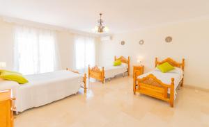a bedroom with two beds in a room at Cubo's Villa Paraiso in Alhaurín el Grande +68 photos