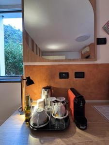 a kitchen counter with a tea set on a tray at Locanda Ca Da Iride in Riomaggiore