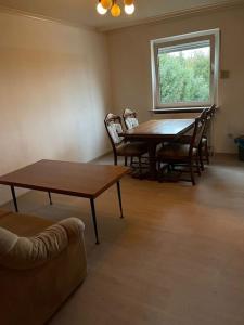 een woonkamer met een tafel en stoelen en een raam bij Ferienhaus, Kassels bester Lage in Kassel