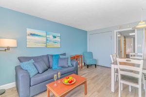 a living room with a couch and a table at Newly Renovated 1 Bedroom Condo- Oceanfront Views! Boardwalk 1139 in Myrtle Beach