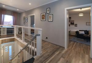 a hallway with a staircase and a living room at Apartment Am Stadtwald in Werne an der Lippe / NRW in Werne an der Lippe