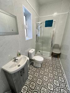 a bathroom with a sink toilet and a shower at Beaconsfield Holiday Apartments in Bridlington