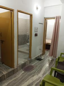 a bathroom with a shower and a mirror at Darbar Homestay in Gaya