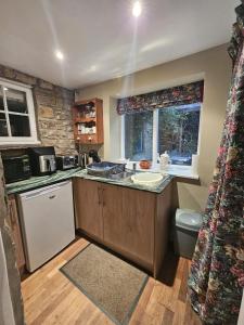 a kitchen with a sink and a counter top at Lakewood Courtyard Northumberland in Healey