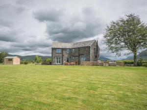 an old stone building in a grass field at 4 Bed in Ennerdale Bridge SZ308 in Cleator